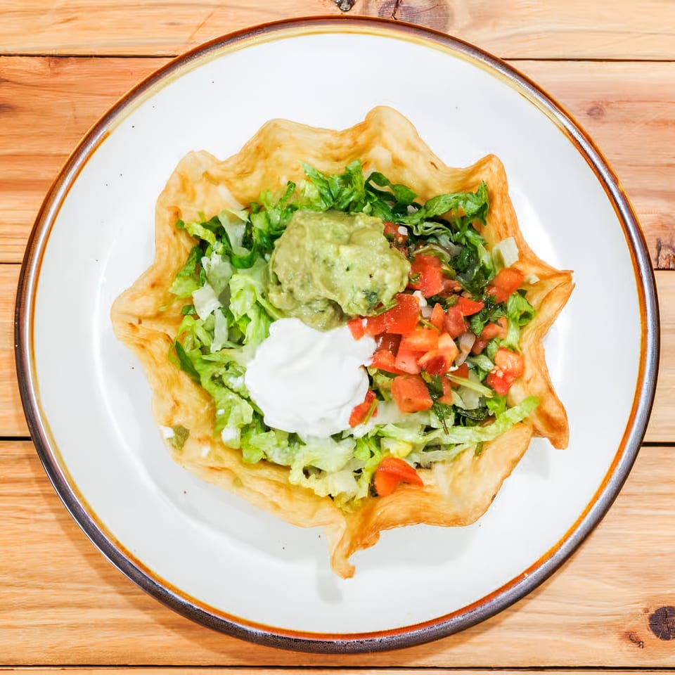 A La Costa Mexican cantina taco salad in a crispy shell with lettuce, guacamole, sour cream, and pico de gallo.